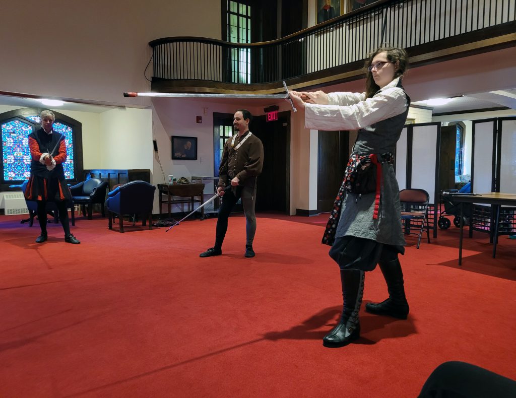 A student in a longsword classes practices her 